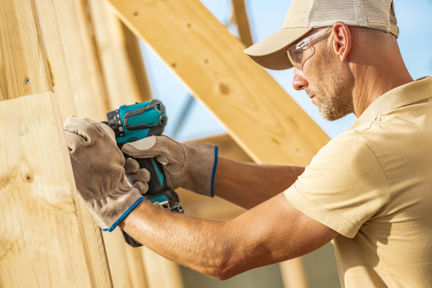 Construction worker in yellow using a tool
